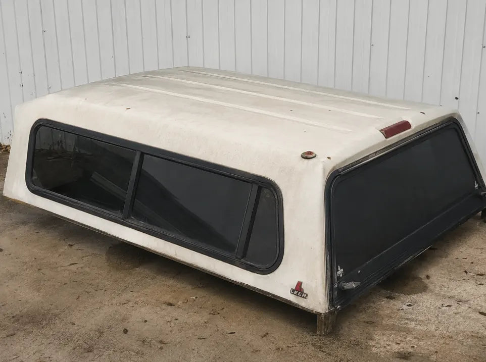 A used, worn-out LEER truck bed cover with an inflated price