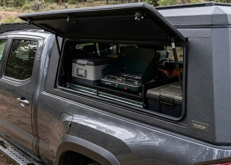 Close up of a Toyota Tacoma camper shell highlighting side access doors