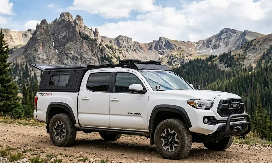 White Toyota pickup truck fitted with an Armacap customizable pickup canopy