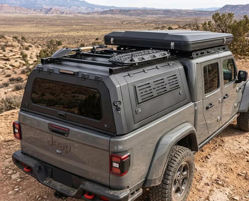 A Jeep truck equipped with a durable truck topper, demonstrating how it protects cargo from the elements.