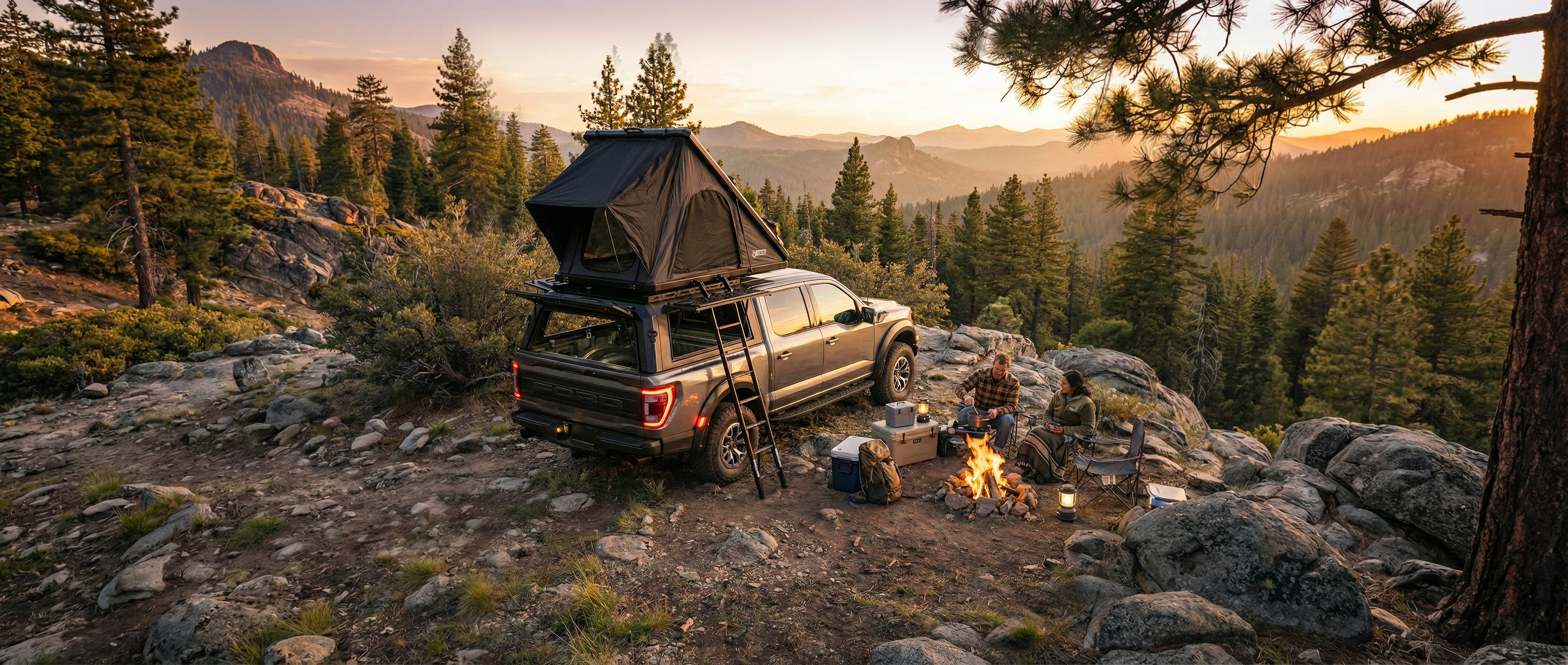 A Ford F-150 equipped with a rugged ArmaCap truck canopy and an open rooftop tent at a mountain campsite during sunset. A couple is relaxing by a campfire next to the truck, which features open gullwing side doors on the canopy. The scene is set in a pine forest overlooking a valley under a warm evening glow.